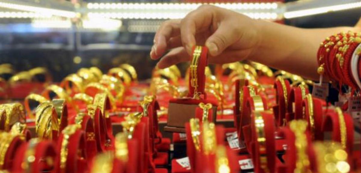 Gold hits two-week high as chances of early Fed rate hike dim